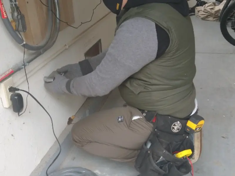 Electrician performing outlet wiring in a Granite Shoals garage